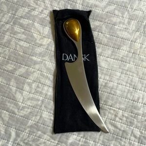 Dansk cheese knife circa 1986. NWOT. Stainless blade with Brass handle.
